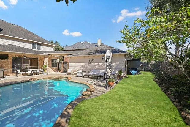 a view of a house with backyard porch and sitting area