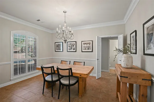 a view of a dining room with furniture and chandelier