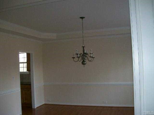 4304 White Chapel Way Raleigh, NC 27615 - Photo 3 of 12 Trey ceiling in dining room, hardwood floors, chair rail and crown molding