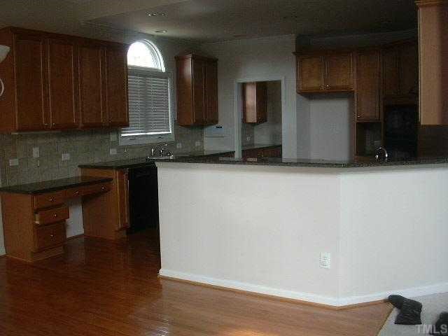 4304 White Chapel Way Raleigh, NC 27615 - Photo 5 of 12 Solid surface countertops, tile backspalsh, hardwood floors, built in desk