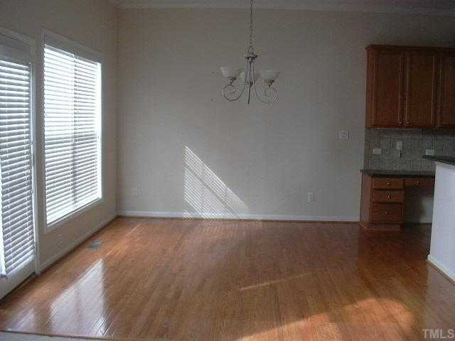 4304 White Chapel Way Raleigh, NC 27615 - Photo 6 of 12 Kitchen eating area, hardwood floors, access to deck