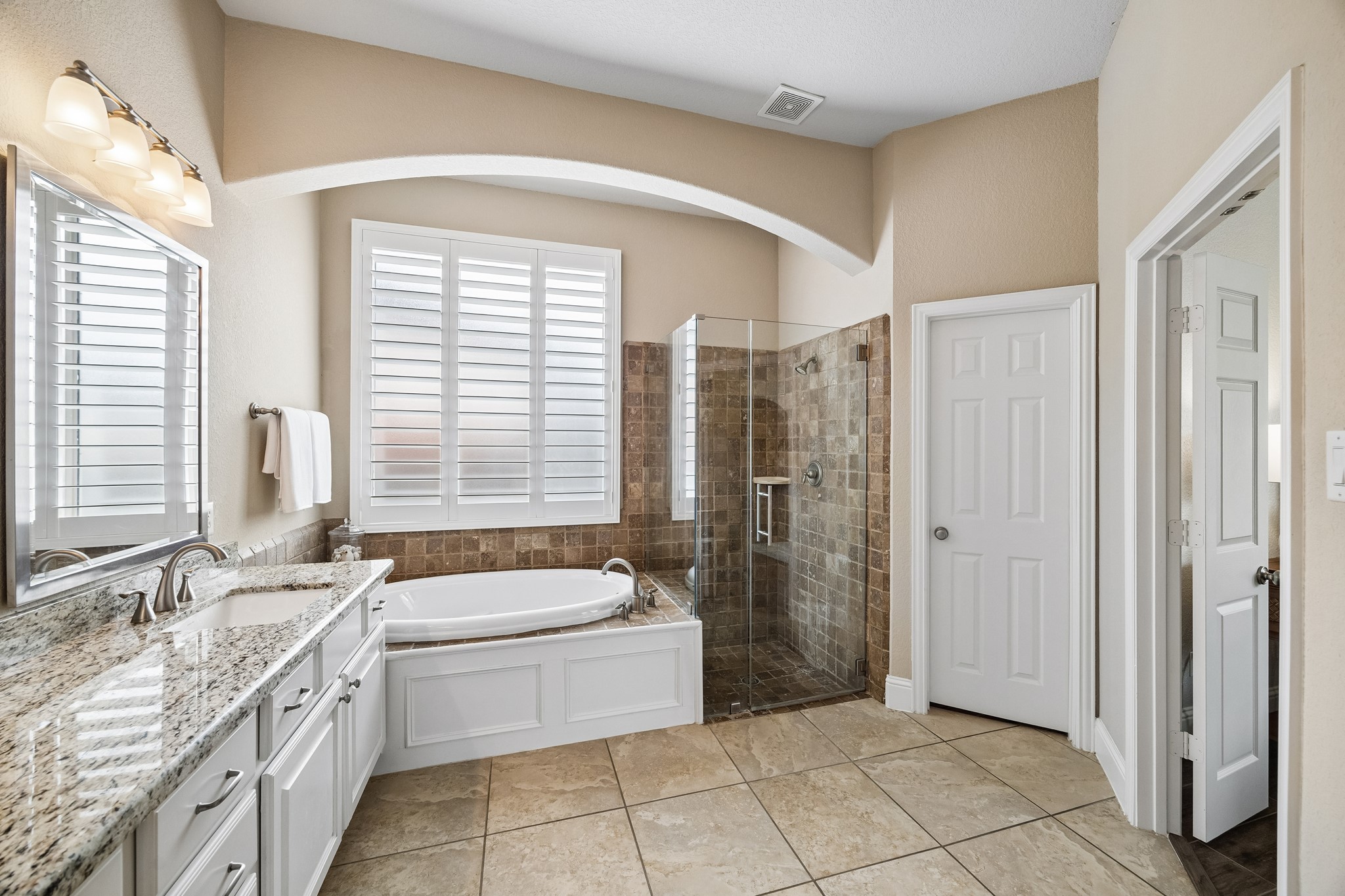 12523 Cedar Key Trail Humble, TX 77346 - Photo 16 of 33 a bathroom with a granite countertop sink a toilet a mirror and shower