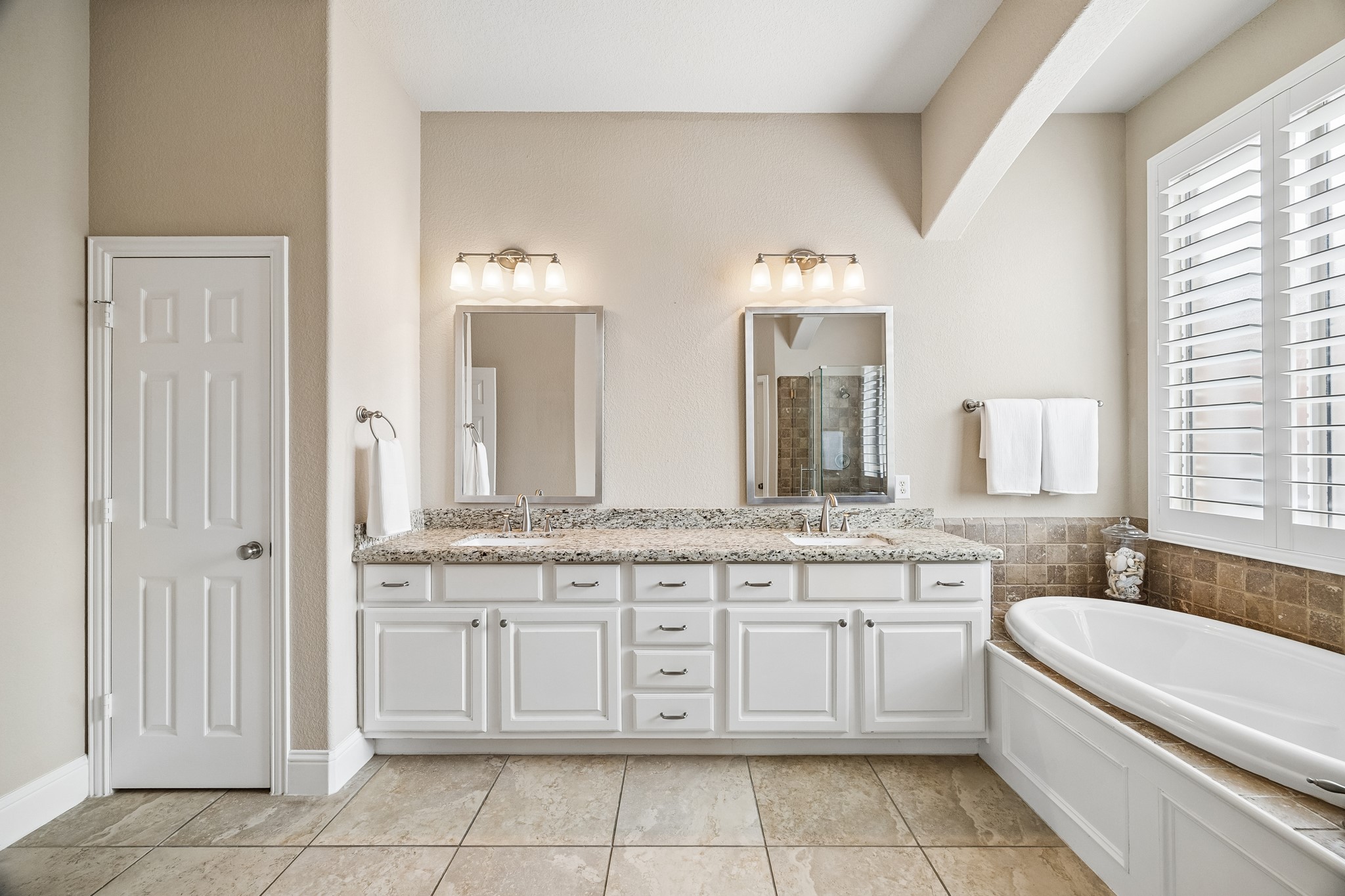 12523 Cedar Key Trail Humble, TX 77346 - Photo 17 of 33 a bathroom with a granite countertop bathtub sink vanity and mirror