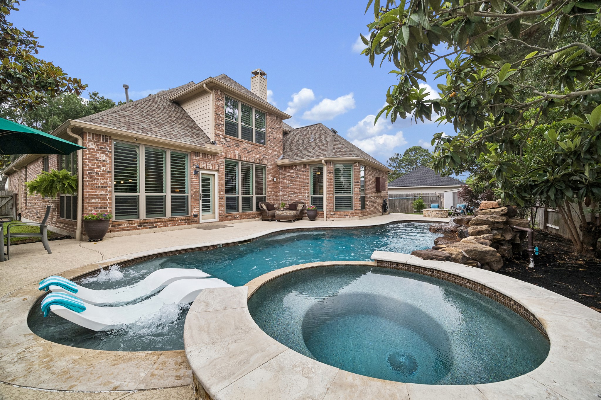 12523 Cedar Key Trail Humble, TX 77346 - Photo 27 of 33 a view of a house with pool fire pit a chairs and a fire pit