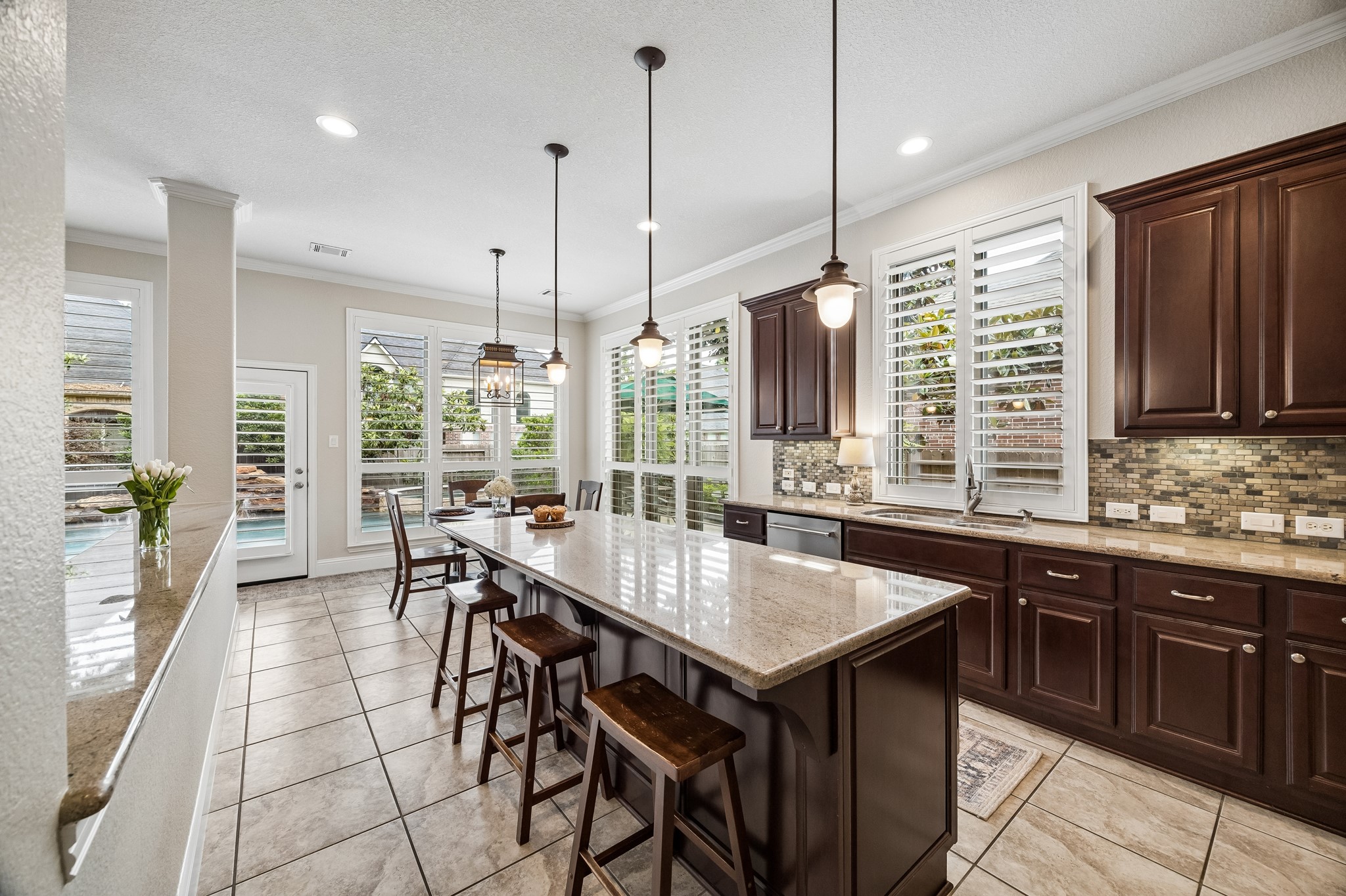 12523 Cedar Key Trail Humble, TX 77346 - Photo 10 of 33 a kitchen with stainless steel appliances granite countertop a stove a sink a oven a dining table and chairs