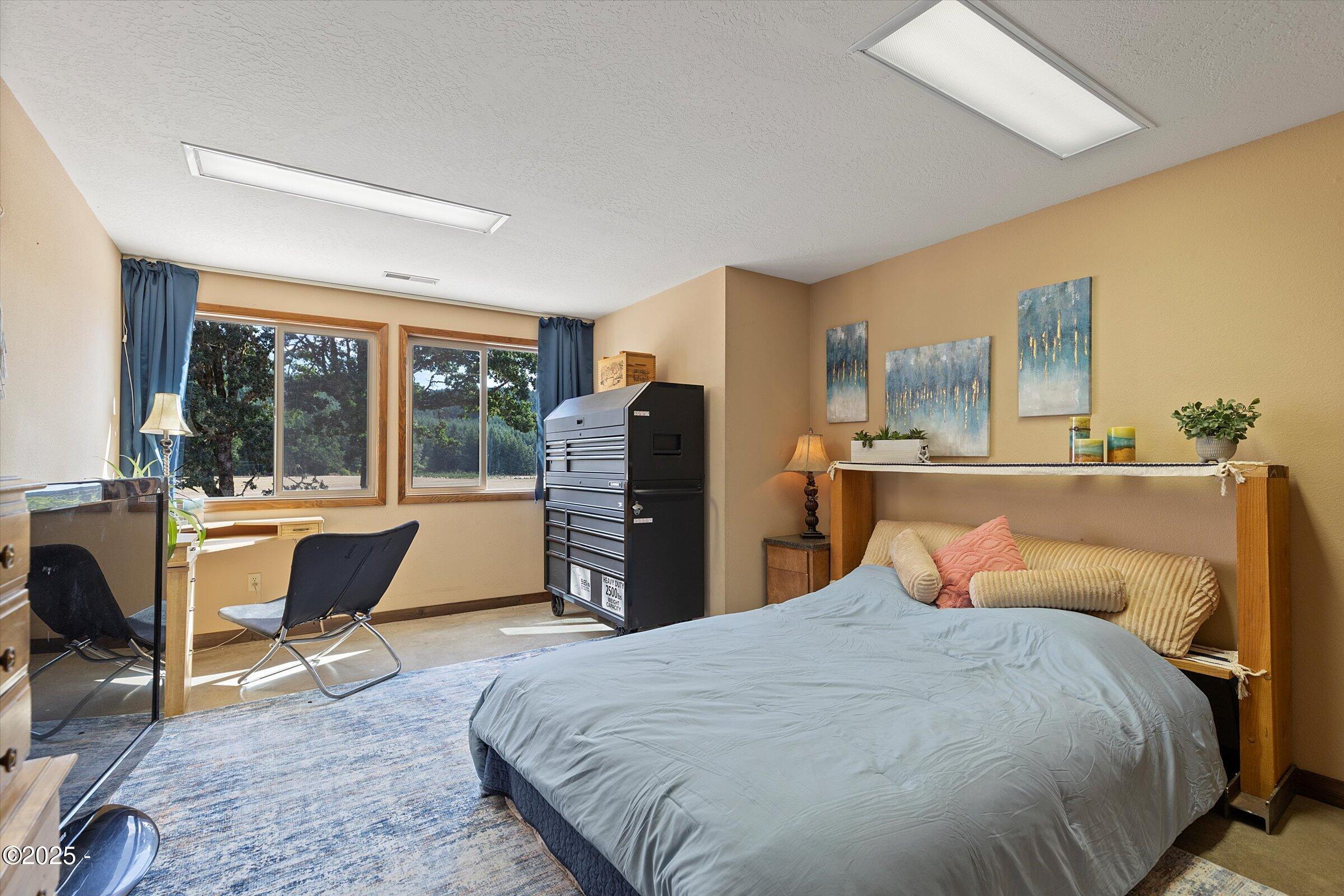 21560 Gooseneck Road Sheridan, OR 97378 - Photo 46 of 63 a bedroom with a bed and wooden floor