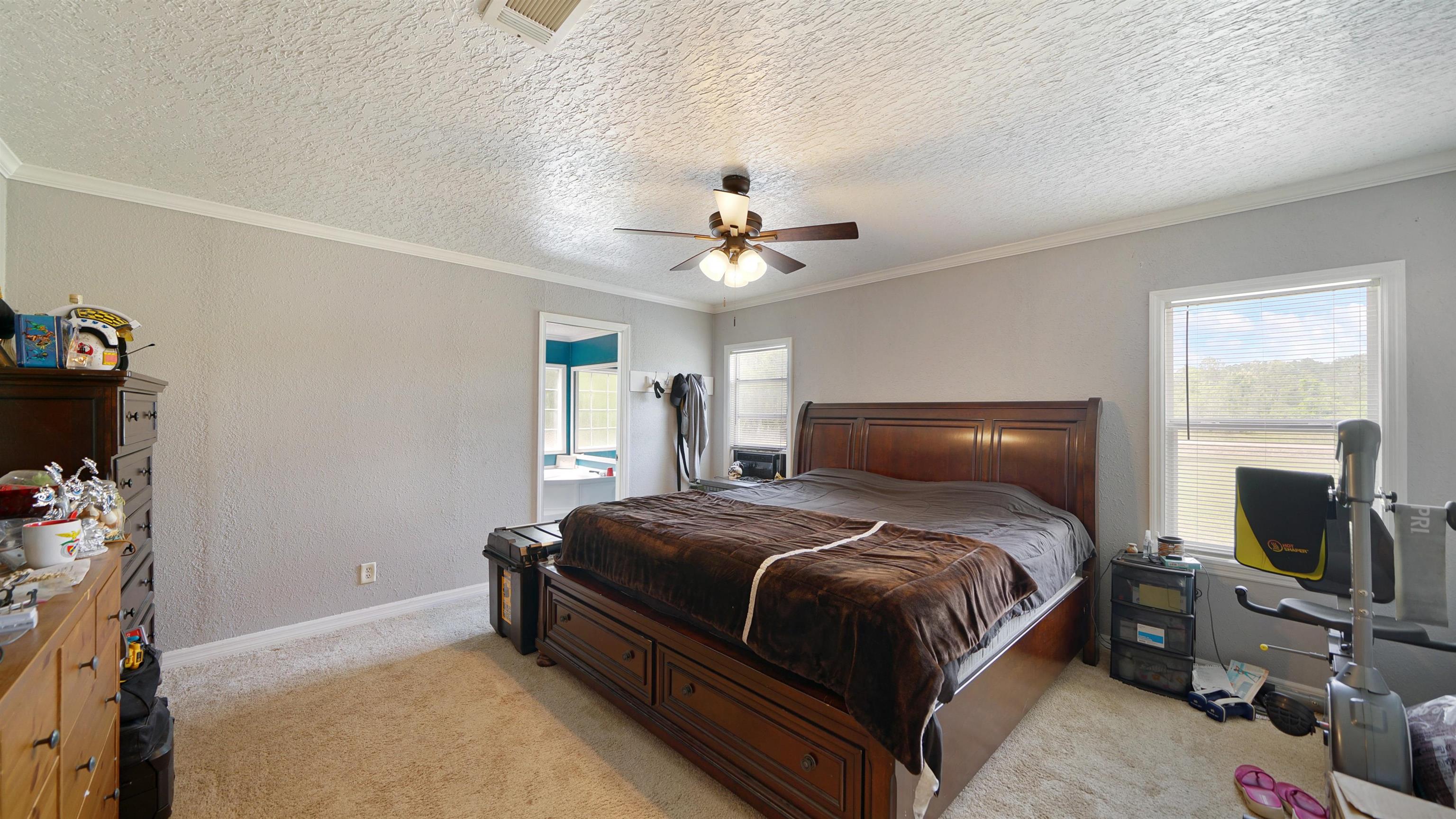 117 Jack Road Palatka, FL 32177 - Photo 12 of 34 a bedroom with a bed and a chandelier