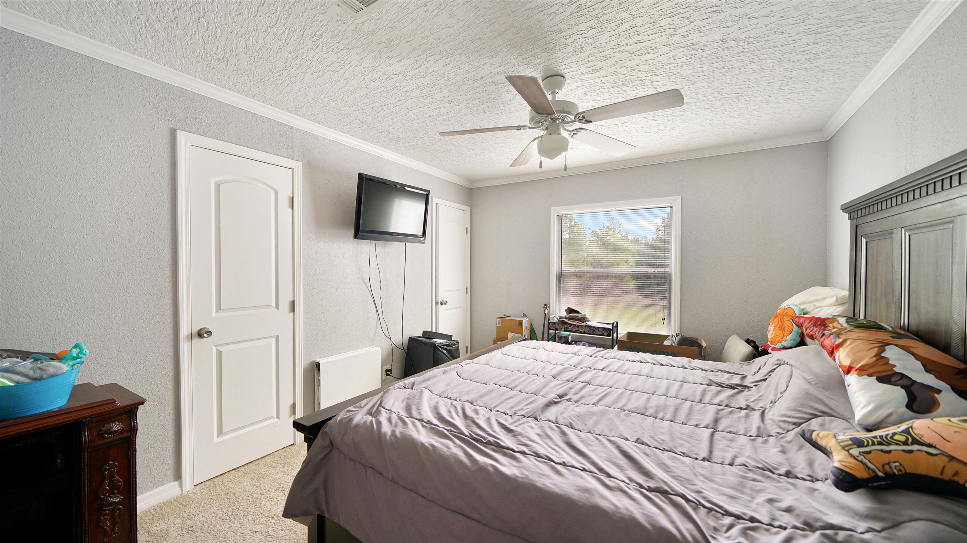 117 Jack Road Palatka, FL 32177 - Photo 21 of 34 a bedroom with a bed and flat screen tv