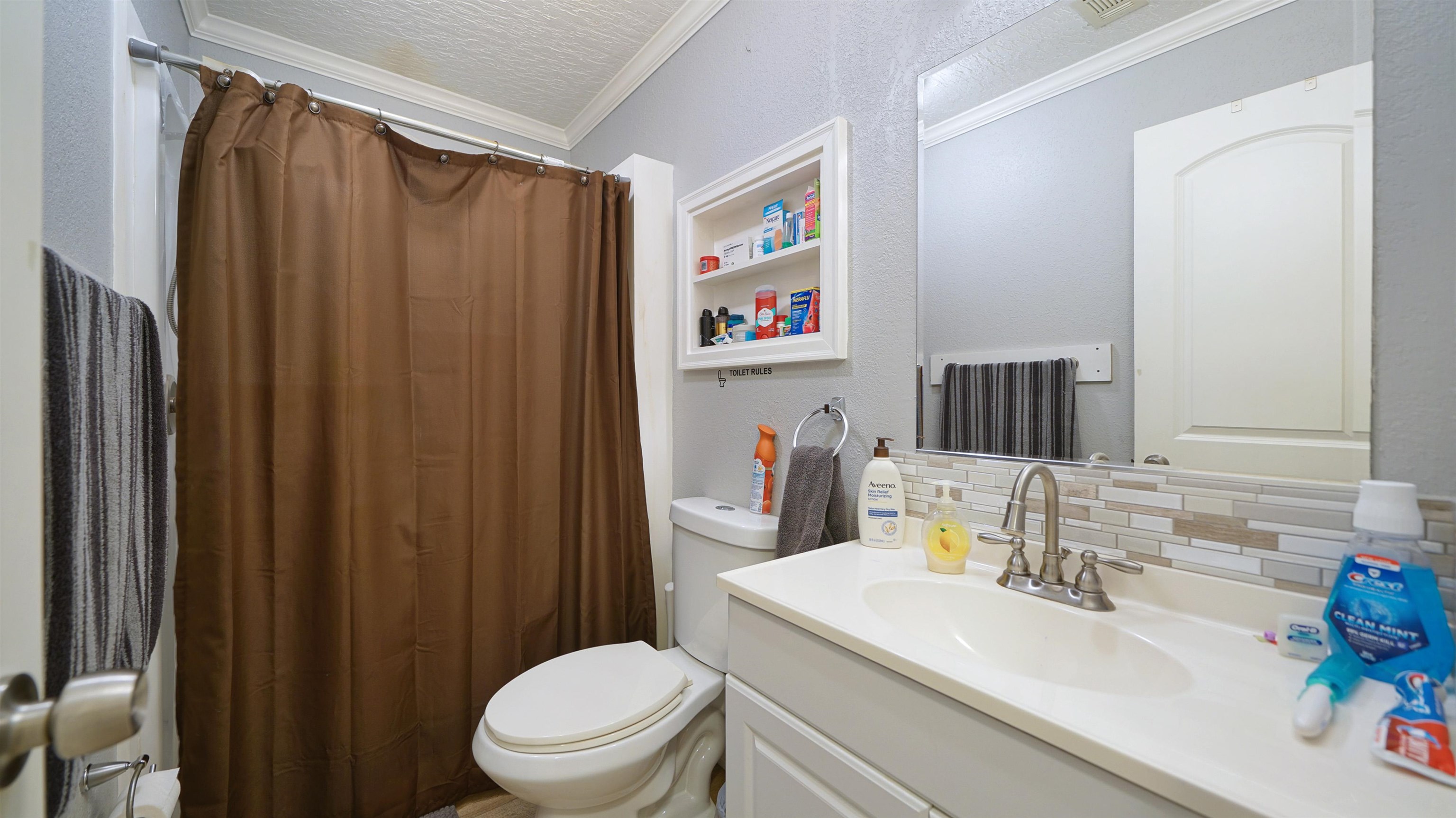 117 Jack Road Palatka, FL 32177 - Photo 22 of 34 a bathroom with a sink a toilet and shower curtain