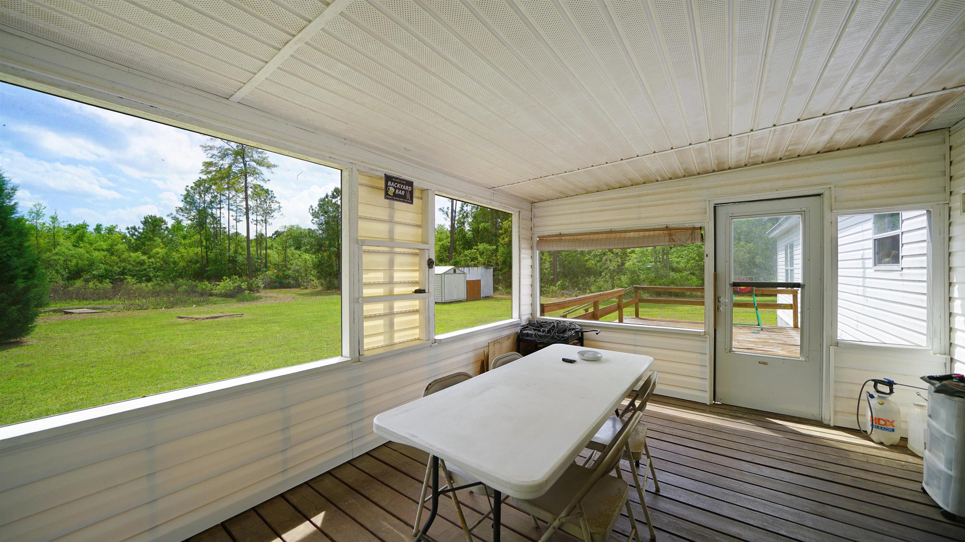 117 Jack Road Palatka, FL 32177 - Photo 25 of 34 a view of a patio with a table chairs and a backyard