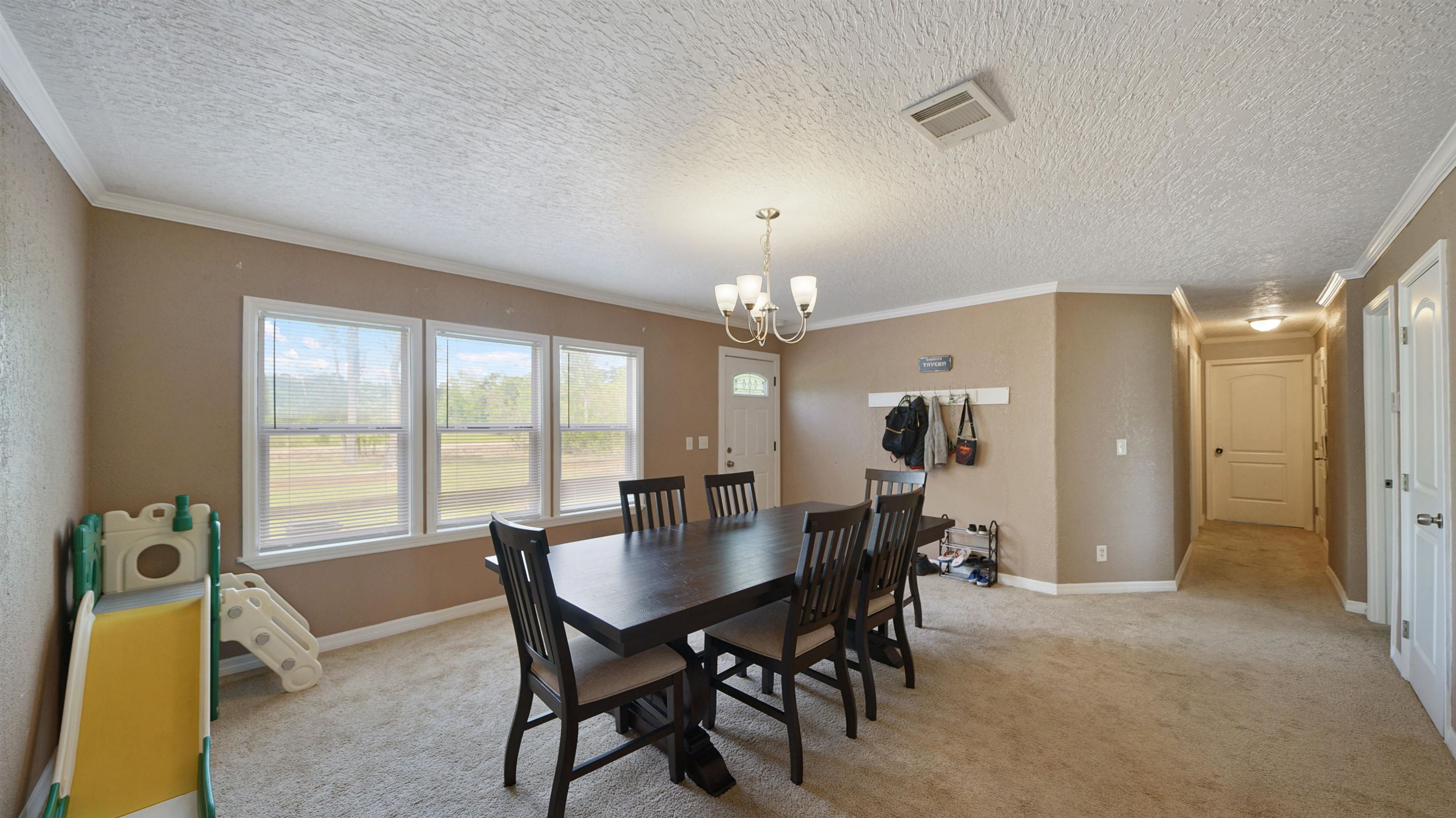117 Jack Road Palatka, FL 32177 - Photo 5 of 34 a view of a dining room with furniture and a chandelier
