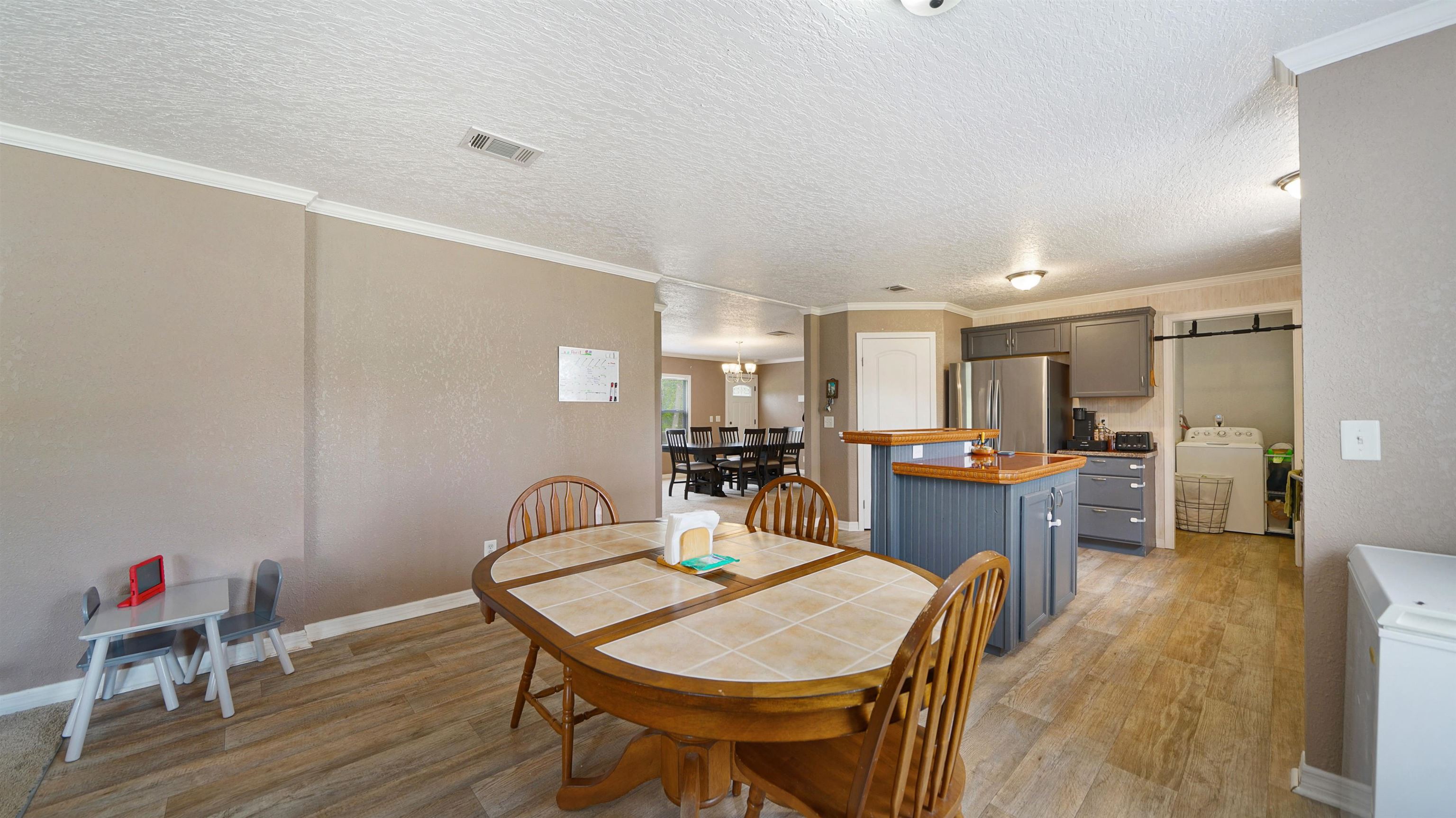 117 Jack Road Palatka, FL 32177 - Photo 7 of 34 a dining room with furniture and wooden floor