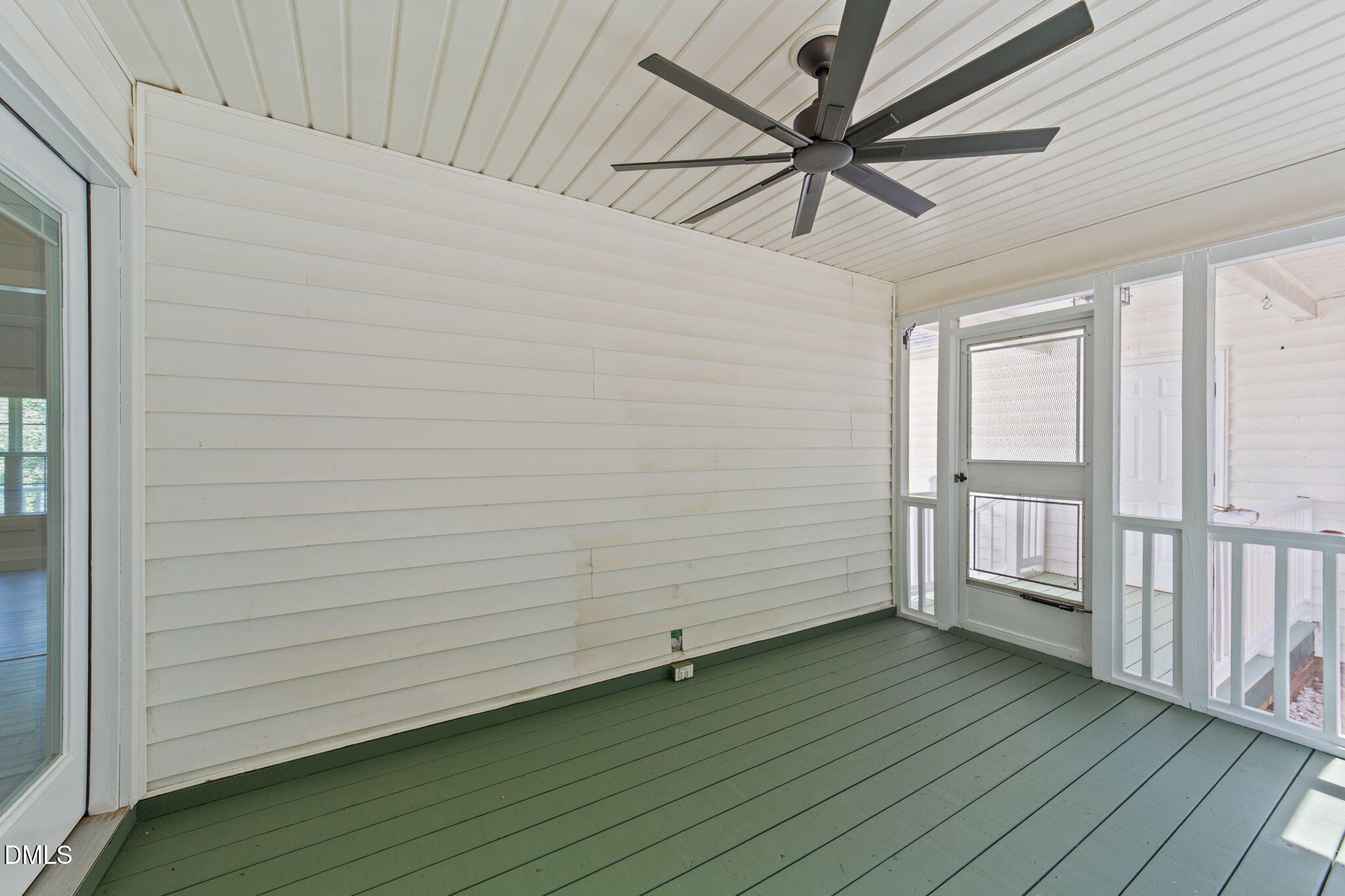 6820 Oviedo Drive Raleigh, NC 27603 - Photo 34 of 50 a view of an empty room with a window and wooden floor