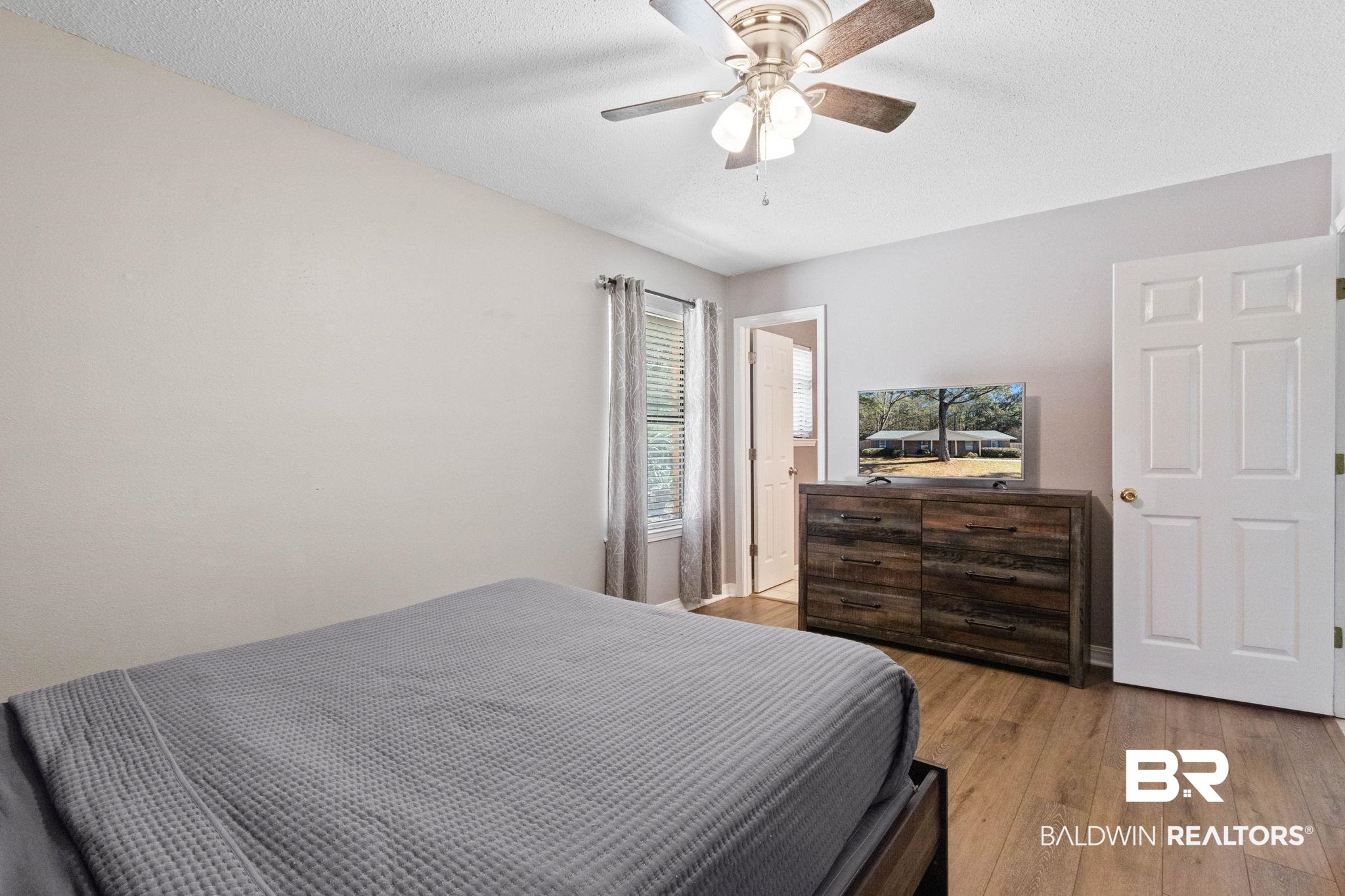 5366 Scanlan Way West Satsuma, AL 36572 - Photo 15 of 43 Bedroom with light wood-type flooring, a ceiling fan, and a textured ceiling