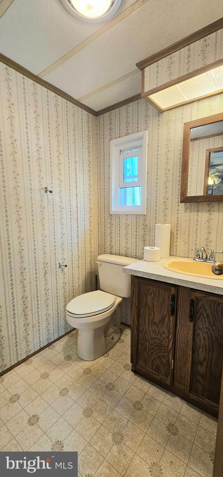10505 Cedarville Road, Unit 1019 Brandywine, MD 20613 - Photo 11 of 15 a bathroom with a sink a toilet and a shower