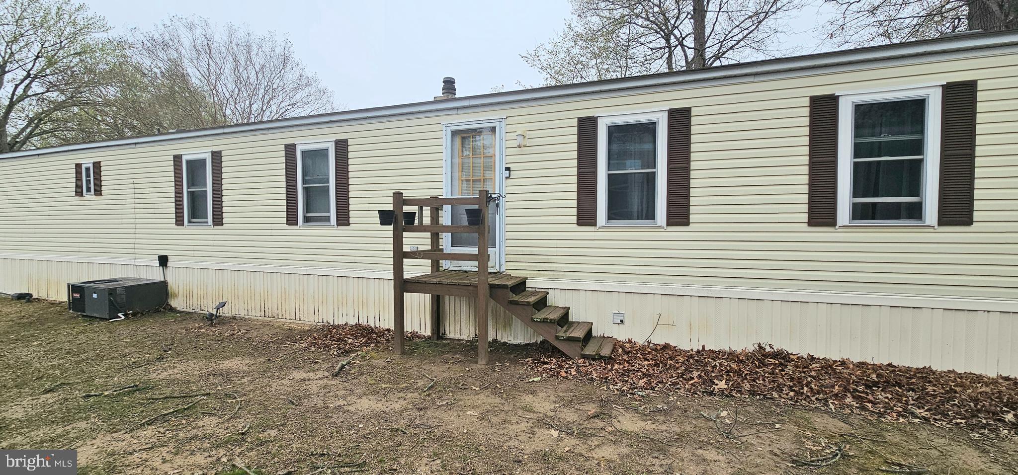 10505 Cedarville Road, Unit 1019 Brandywine, MD 20613 - Photo 14 of 15 a view of a house with a yard and a chair