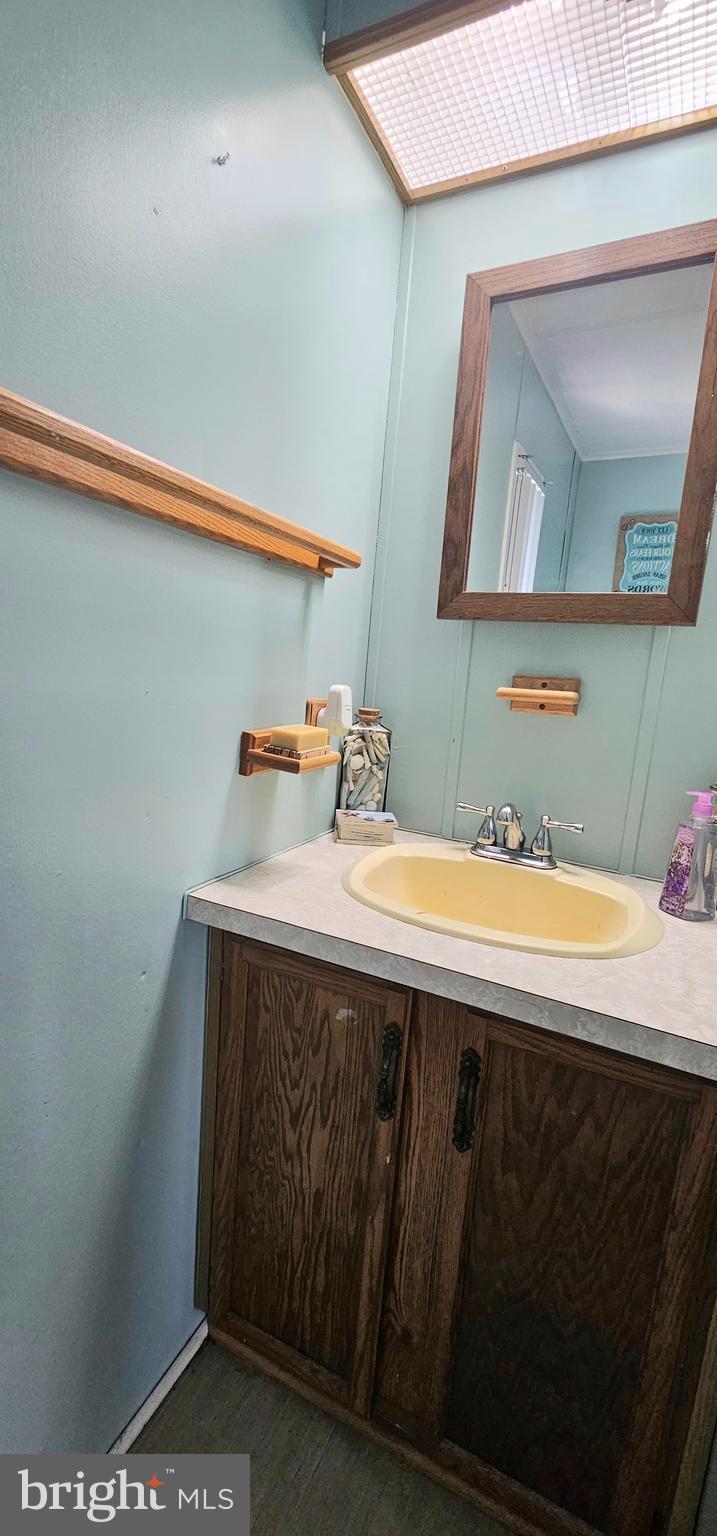 10505 Cedarville Road, Unit 1019 Brandywine, MD 20613 - Photo 8 of 15 a bathroom with a sink and a mirror