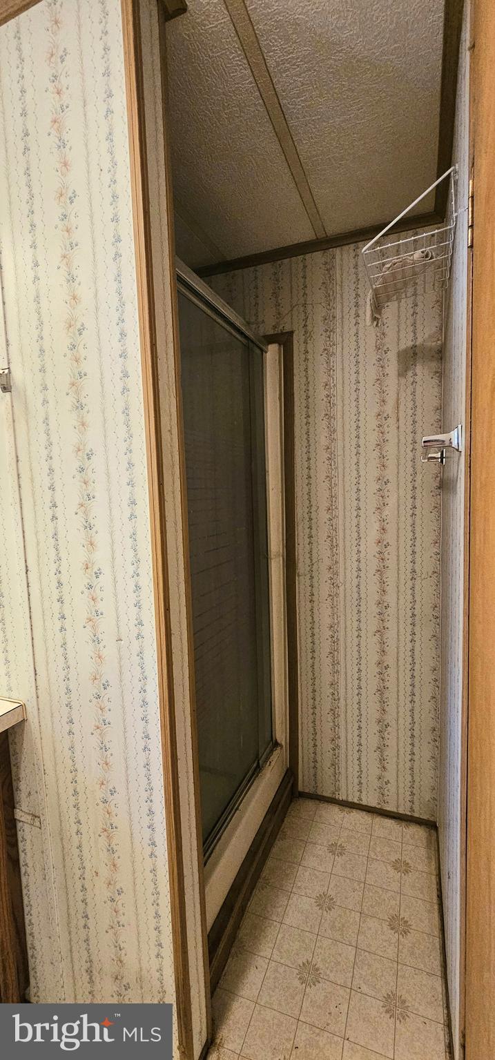 10505 Cedarville Road, Unit 1019 Brandywine, MD 20613 - Photo 10 of 15 a view of a bathroom with a shower and a sink