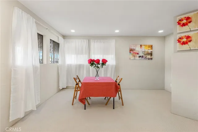 a dining room with furniture and window