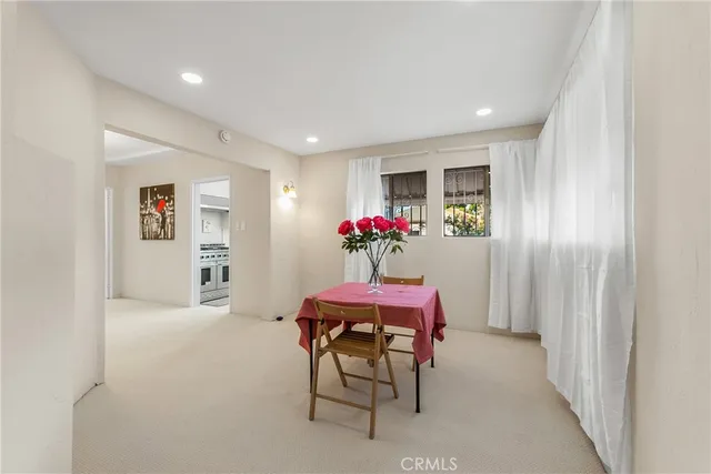 a dining room with furniture and window