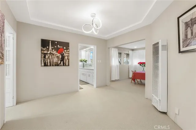a view of a livingroom with workspace and a window