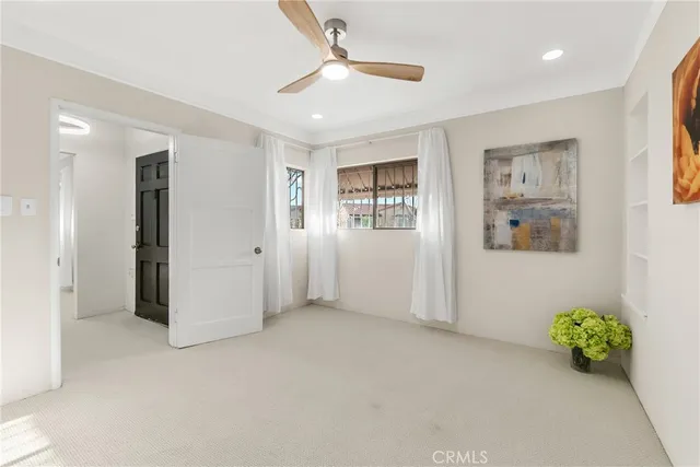 a view of an empty room with window and closet area
