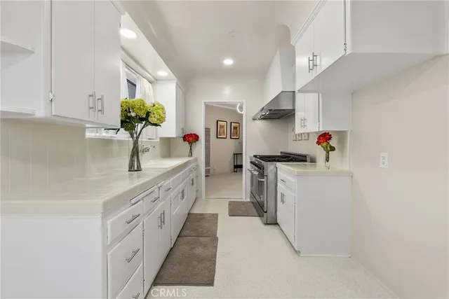 a kitchen with stainless steel appliances granite countertop a sink and cabinets