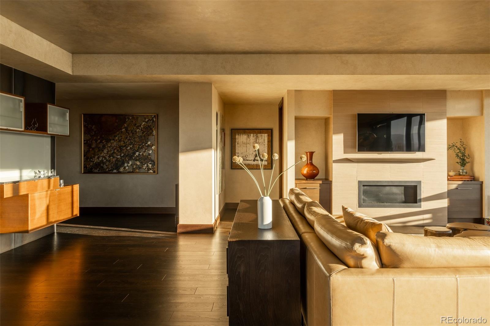 1133 14th Street, Unit 2900 Denver, CO 80202 - Photo 16 of 48 a living room with fireplace furniture and a flat screen tv