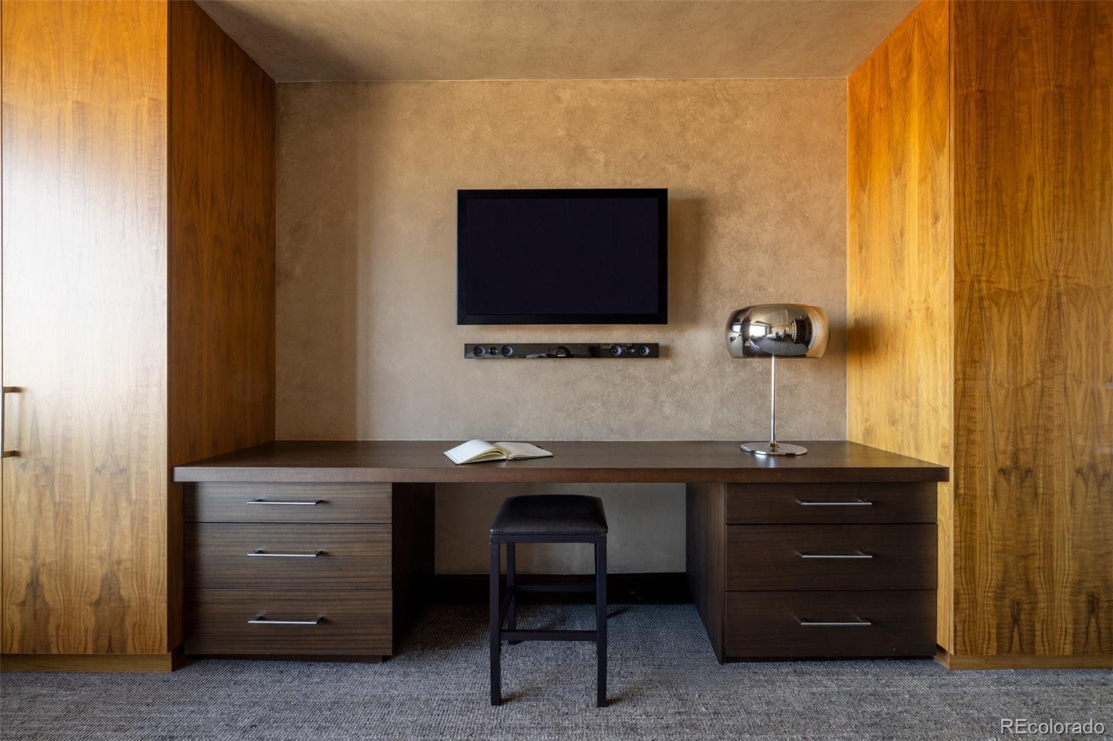 1133 14th Street, Unit 2900 Denver, CO 80202 - Photo 30 of 48 a room with a chair and frames on wall