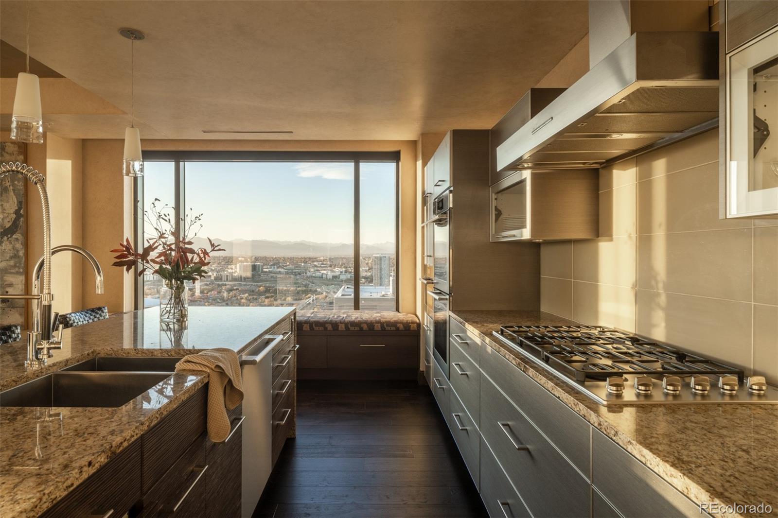 1133 14th Street, Unit 2900 Denver, CO 80202 - Photo 9 of 48 a kitchen with granite countertop a sink and a stove