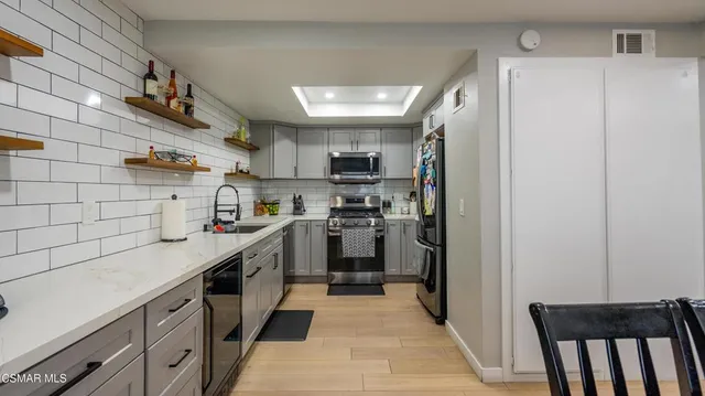 a kitchen with cabinets and stainless steel appliances