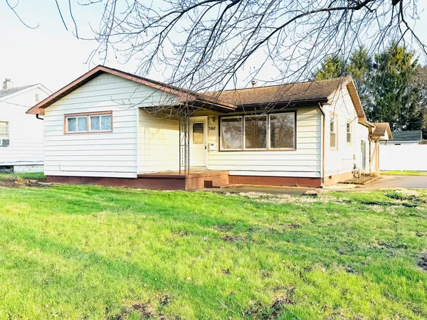 a view of a house with a backyard