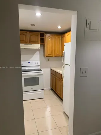 a kitchen with a stove top oven and cabinets