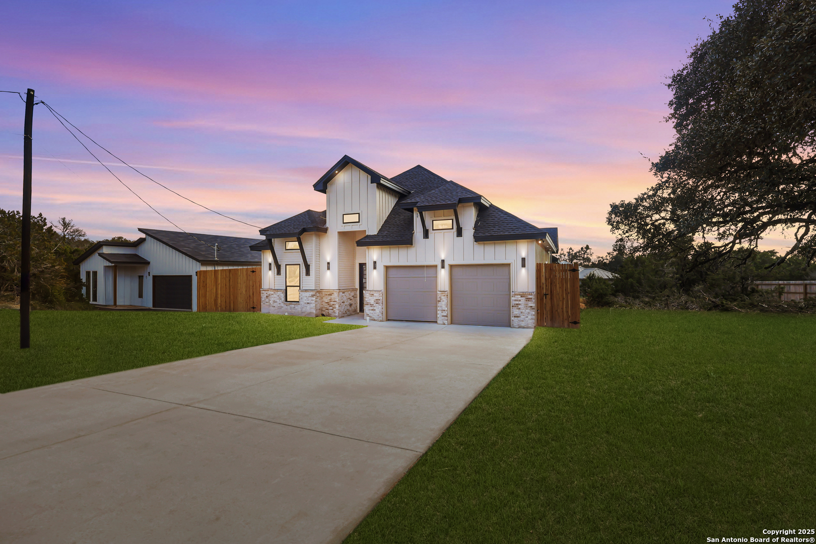1416 Green Meadow Lane Spring Branch, TX 78070 - Photo 1 of 1 a front view of a house with a yard and garage