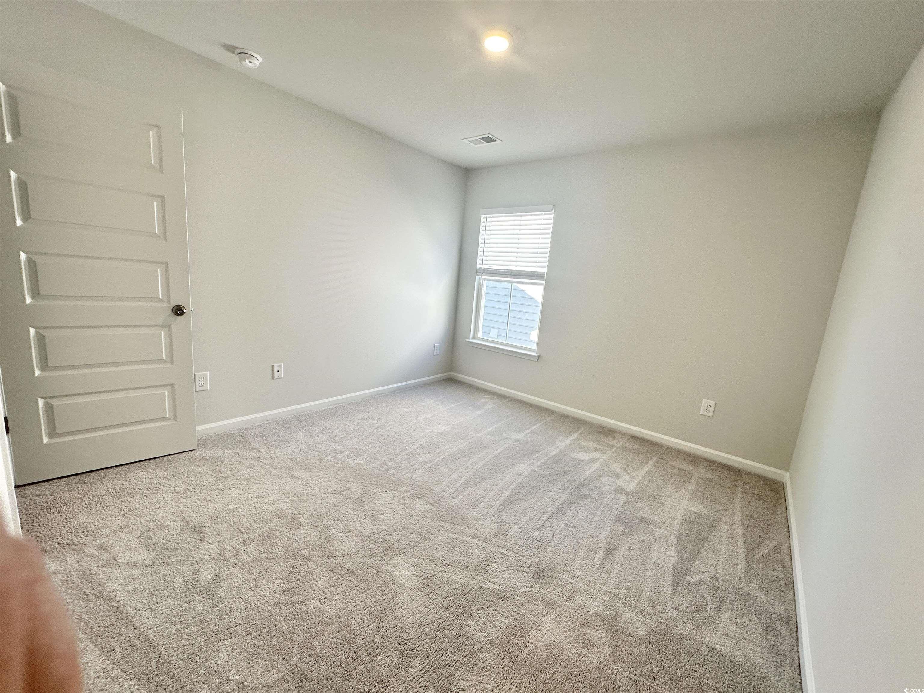 285 Augusta Grn Way Myrtle Beach, SC 29579 - Photo 18 of 28 Unfurnished room with light colored carpet and baseboards