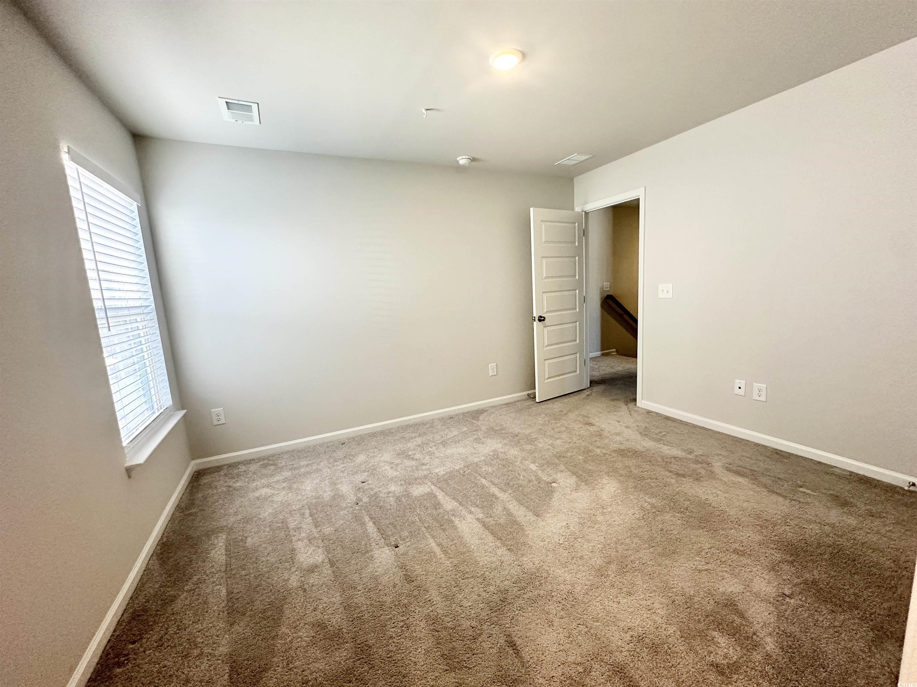 285 Augusta Grn Way Myrtle Beach, SC 29579 - Photo 20 of 28 Empty room featuring baseboards and carpet floors