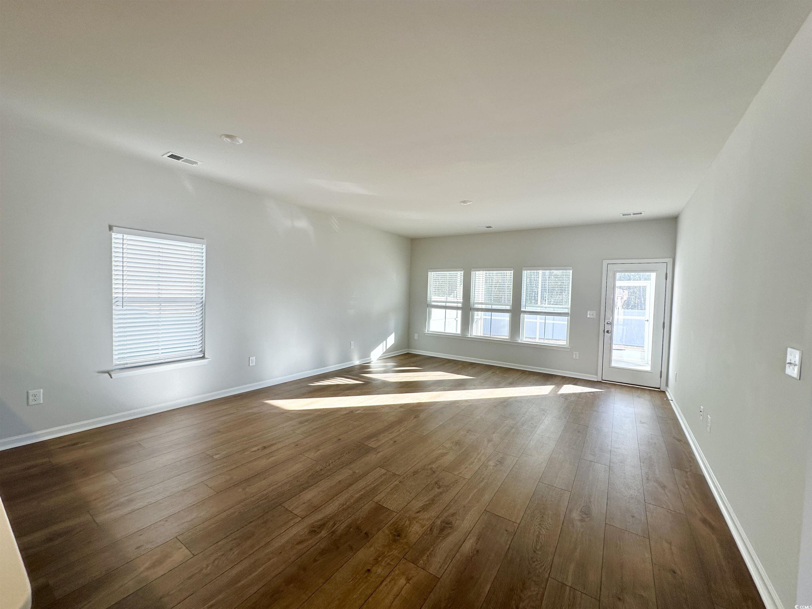 285 Augusta Grn Way Myrtle Beach, SC 29579 - Photo 4 of 28 Spare room with dark wood finished floors and baseboards