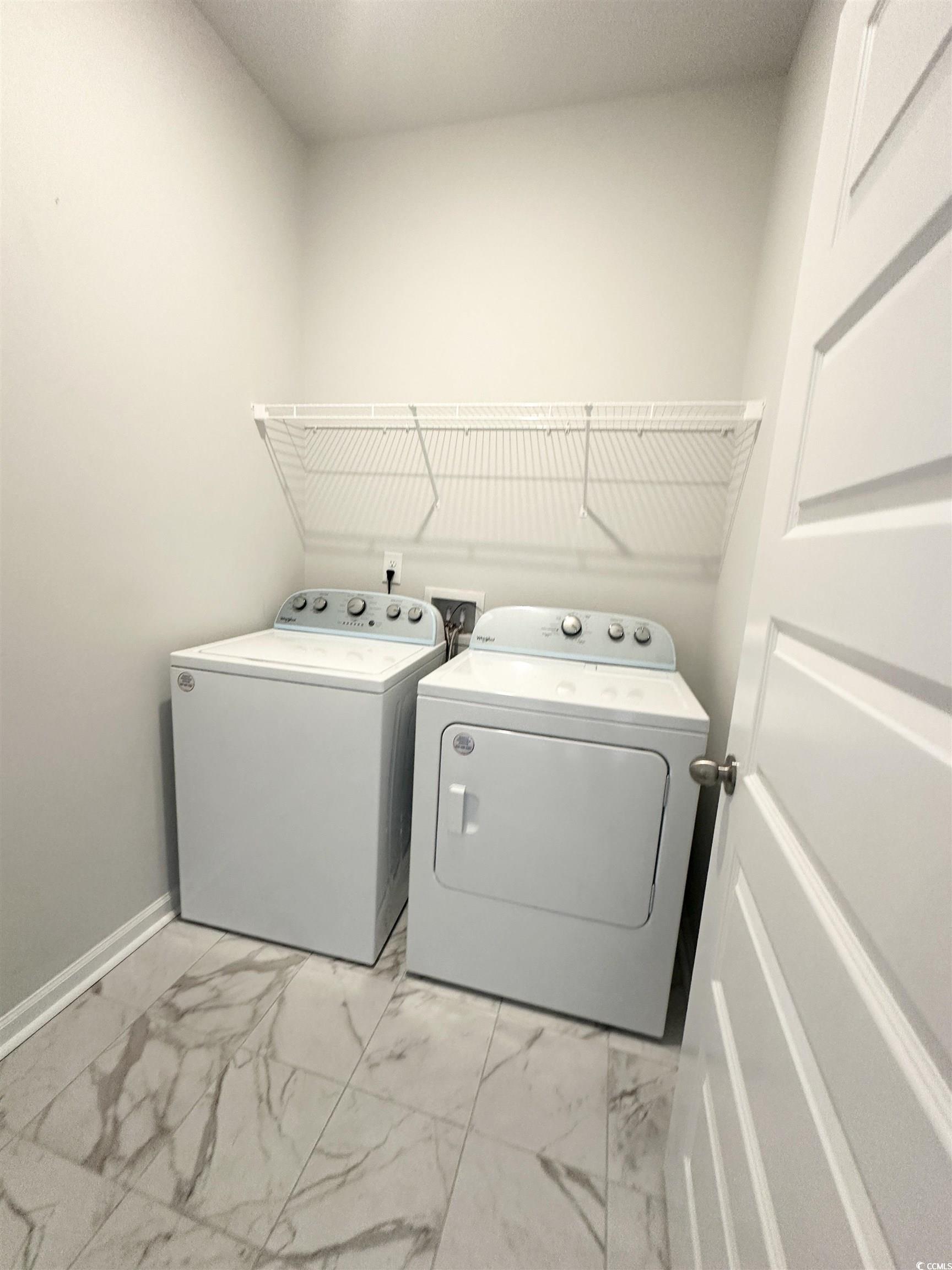 285 Augusta Grn Way Myrtle Beach, SC 29579 - Photo 8 of 28 Laundry room with light marble finish floors and washing machine and clothes dryer
