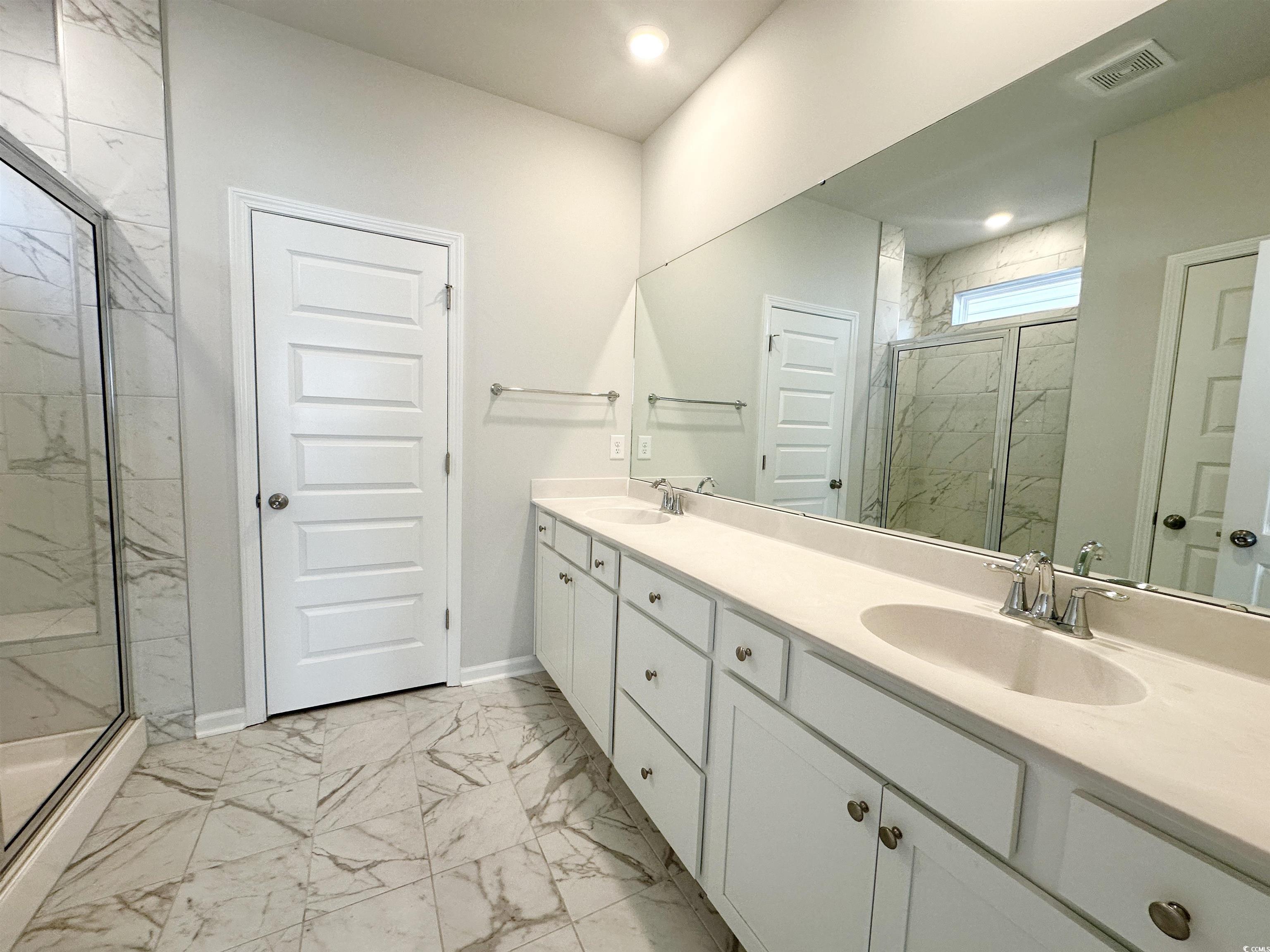 285 Augusta Grn Way Myrtle Beach, SC 29579 - Photo 9 of 28 Full bathroom featuring light marble finish flooring, double vanity, and a marble finish shower