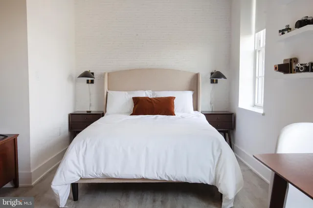 a bedroom with a bed and window