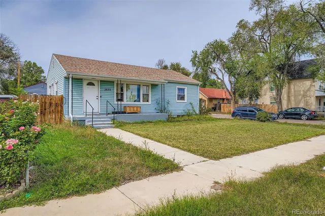 a front view of house with yard and green space