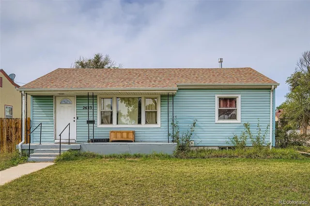 a front view of house with a garden