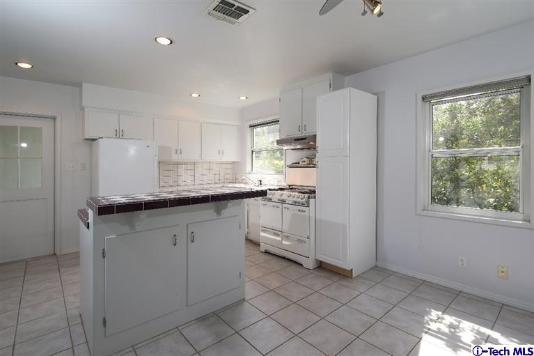 183 Marathon Road Altadena, CA 91001 - Photo 3 of 16 a kitchen with white cabinets and window