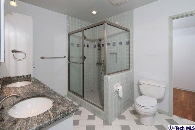 183 Marathon Road Altadena, CA 91001 - Photo 5 of 16 a bathroom with a granite countertop sink toilet a shower and a mirror
