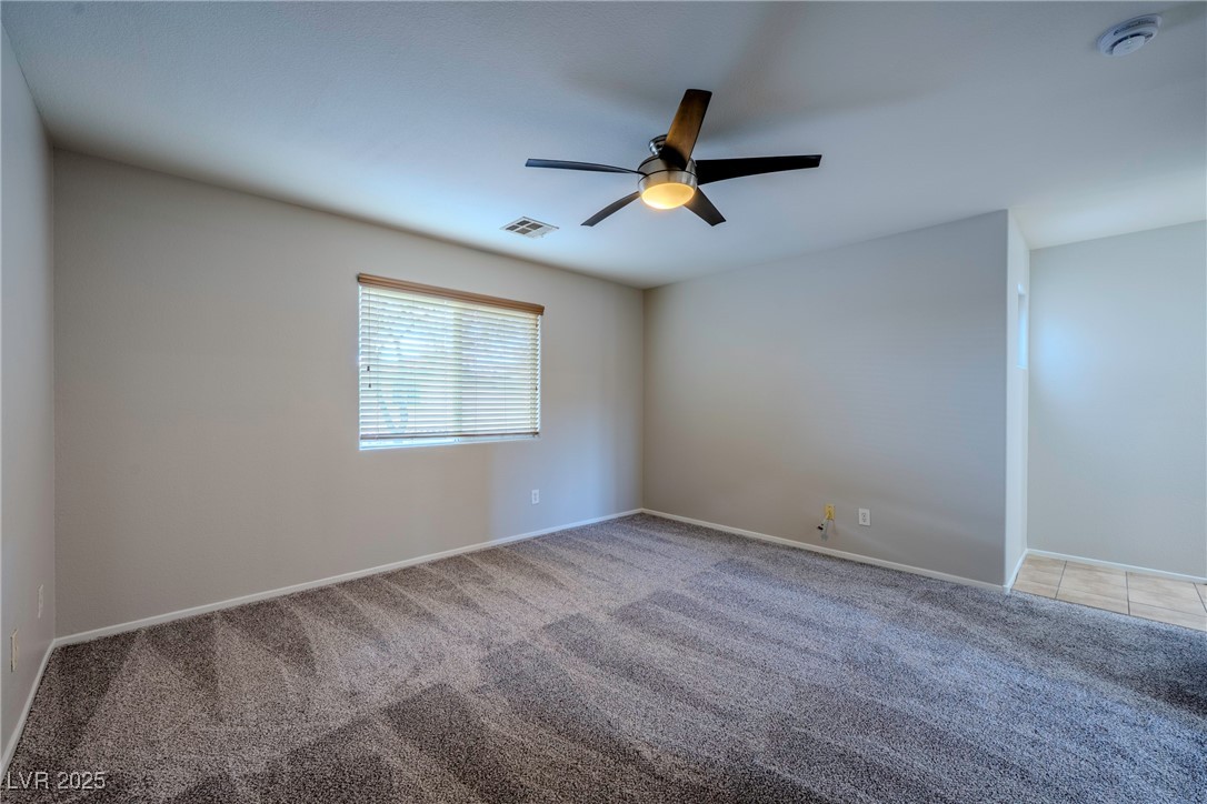 5283 Broadlake Lane Las Vegas, NV 89122 - Photo 12 of 36 Carpeted empty room featuring baseboards and ceiling fan