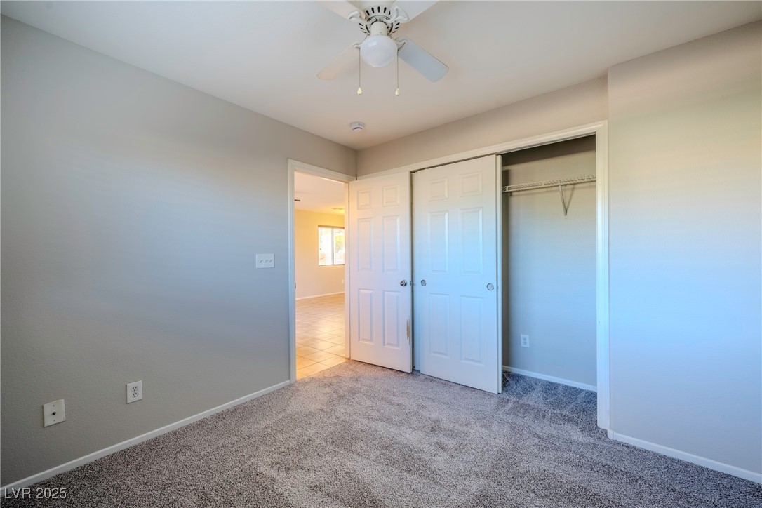 5283 Broadlake Lane Las Vegas, NV 89122 - Photo 24 of 36 Unfurnished bedroom with a ceiling fan, a closet, and carpet floors