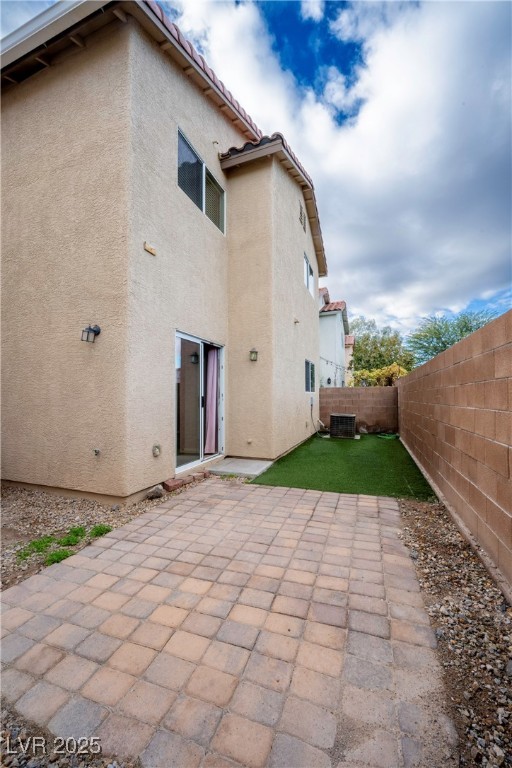 5283 Broadlake Lane Las Vegas, NV 89122 - Photo 35 of 36 Rear view of house with stucco siding, a fenced backyard, a patio, and a tiled roof