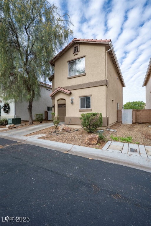 5283 Broadlake Lane Las Vegas, NV 89122 - Photo 4 of 36 Mediterranean / spanish-style house with driveway, stucco siding, and an attached garage