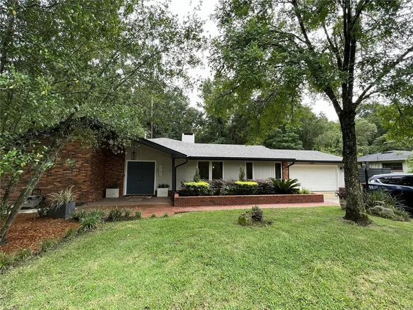 a front view of house with deck and yard