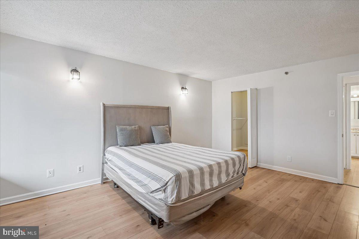 9200 Edwards Way, Unit 1202 Hyattsville, MD 20783 - Photo 14 of 34 a bedroom with a bed and a window